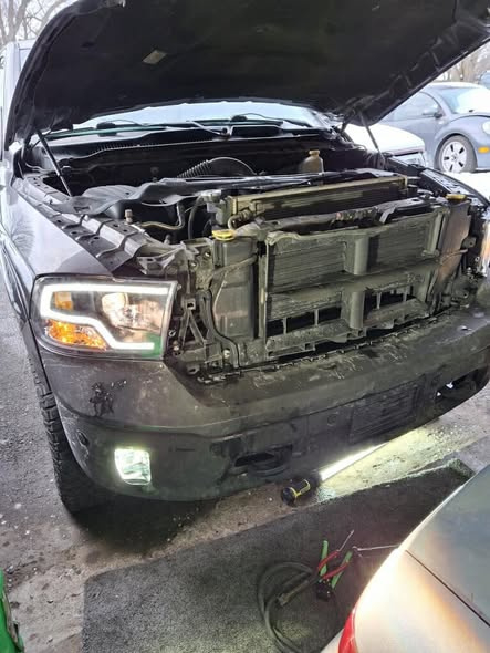 Truck with hood up — front-end and headlight repair